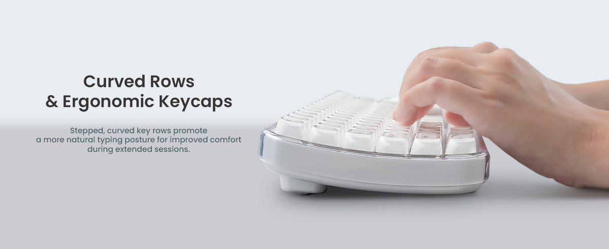 Text reads: 'Curved Rows & Ergonomic Keycaps'. White ergonomic computer keyboard with curved design, hand shown pressing keys demonstrating usage.
