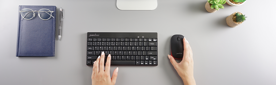 a woman's hands are typing on a keyboard.